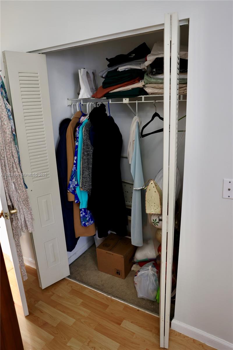 11049 Southwest 152nd Court Miami, FL 33196 - Photo 43 of 57 a view of walk in closet with clothes and shoes