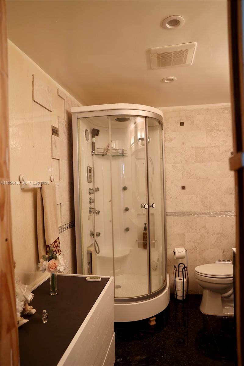 11049 Southwest 152nd Court Miami, FL 33196 - Photo 44 of 57 a bathroom with a double vanity sink toilet and shower