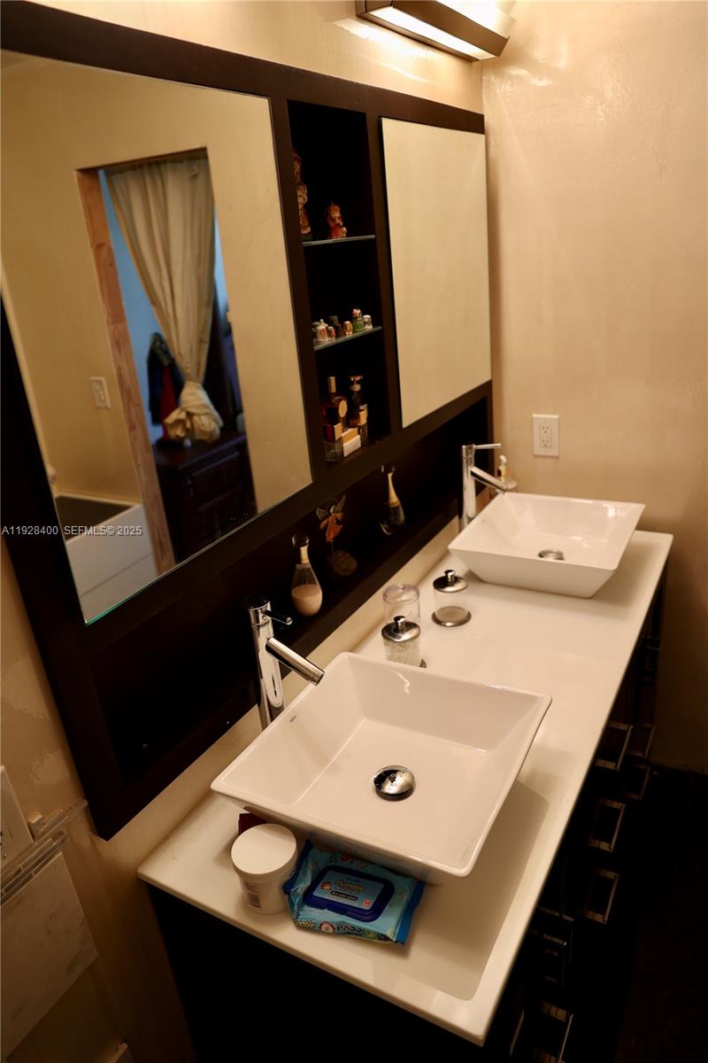 11049 Southwest 152nd Court Miami, FL 33196 - Photo 46 of 57 a bathroom with a sink and a mirror
