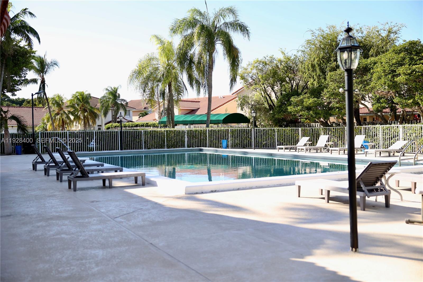 11049 Southwest 152nd Court Miami, FL 33196 - Photo 56 of 57 a view of a patio with a swimming pool and sitting area