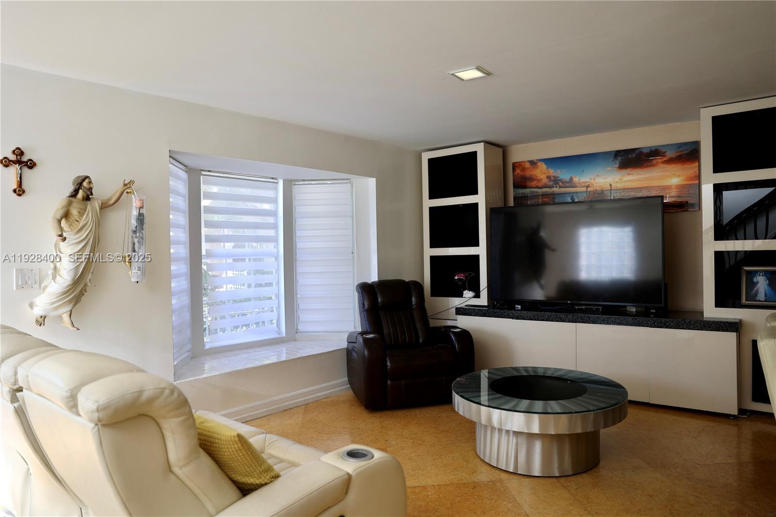 11049 Southwest 152nd Court Miami, FL 33196 - Photo 8 of 57 a living room with furniture and a flat screen tv