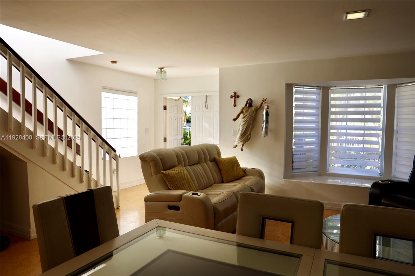 11049 Southwest 152nd Court Miami, FL 33196 - Photo 10 of 57 a living room with furniture and a flat screen tv