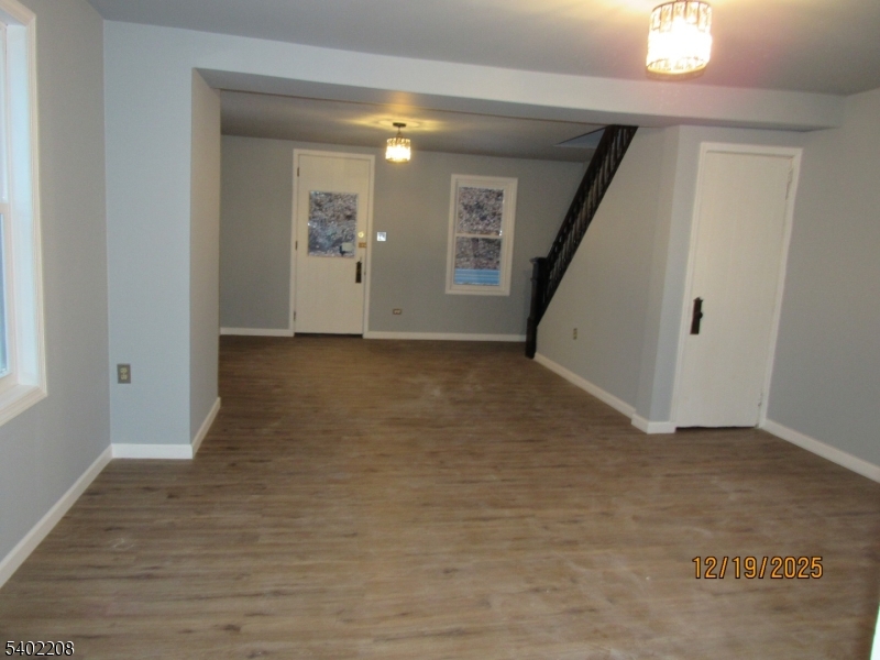 552 Milford Frenchtown Road Milford, NJ 08848 - Photo 12 of 26 an empty room with wooden floor and stairs