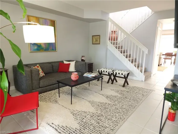 a living room with furniture and a rug