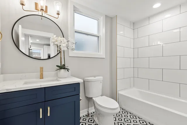 a bathroom with a sink a toilet and a mirror