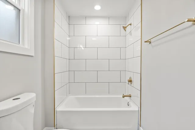 a bathroom with a bathtub and a toilet