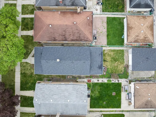 an aerial view of a house with a yard