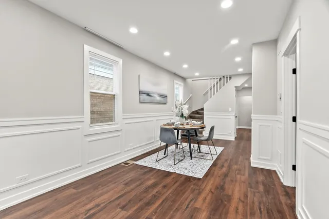 a view of a dining room with furniture and wooden floor