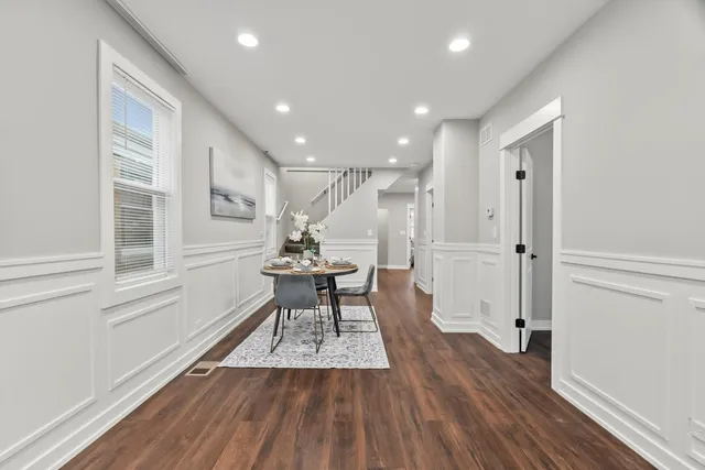 a open kitchen with white cabinets and stainless steel appliances