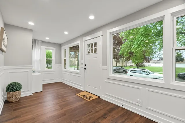 a view of an entryway with wooden floor and windows