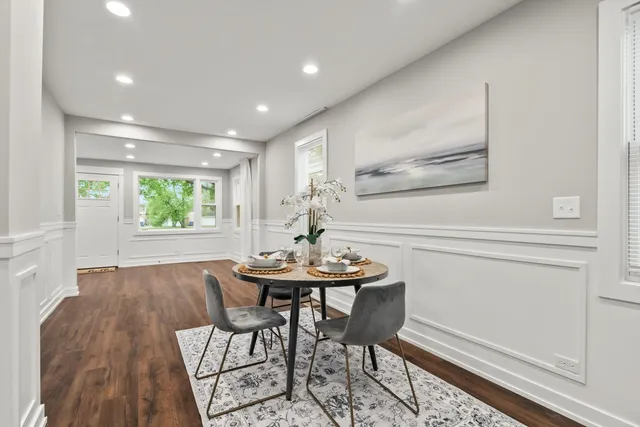 a dining room with furniture and window
