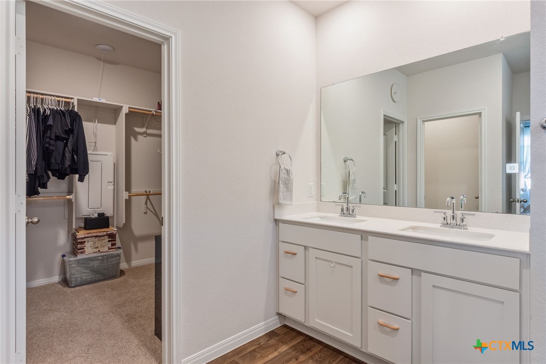 205 Charles Trail Georgetown, TX 78626 - Photo 13 of 38 a en suite bathroom with a double vanity sink and a mirror