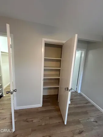 a view of walk in closet with empty racks
