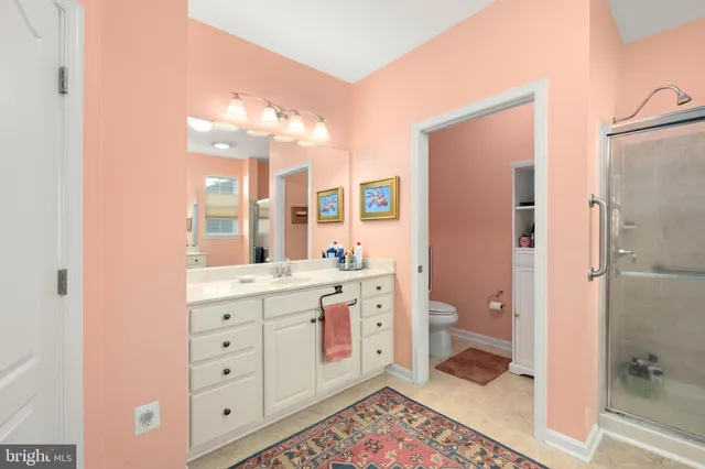 a spacious bathroom with a double vanity sink a mirror and a shower