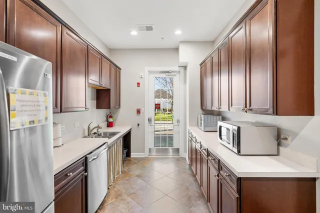 a kitchen with stainless steel appliances a sink stove and cabinets