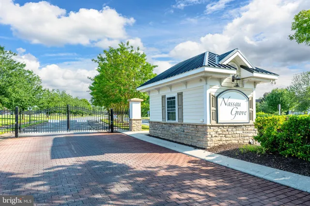 a front view of a house with a yard and a garage