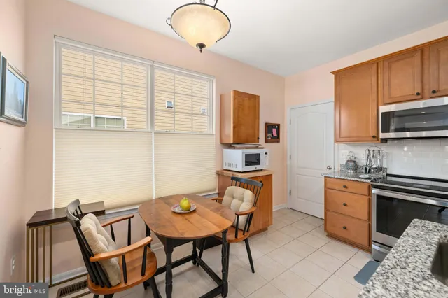 a kitchen with stainless steel appliances wooden cabinets and a stove top oven
