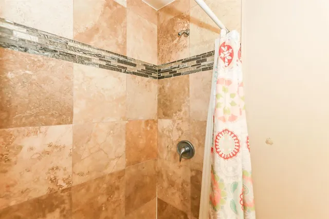 a bathroom with a shower and a shower curtain