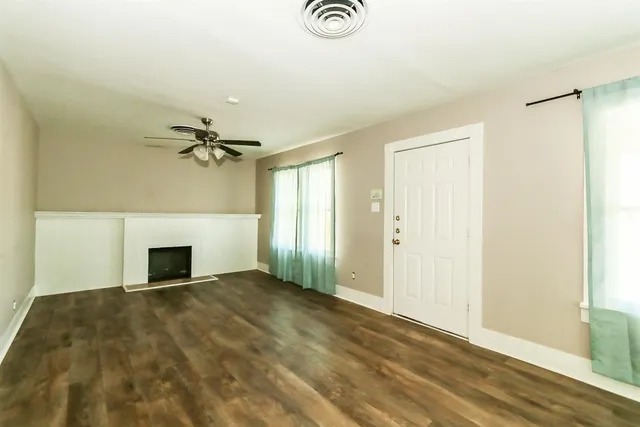 a view of empty room with a fireplace