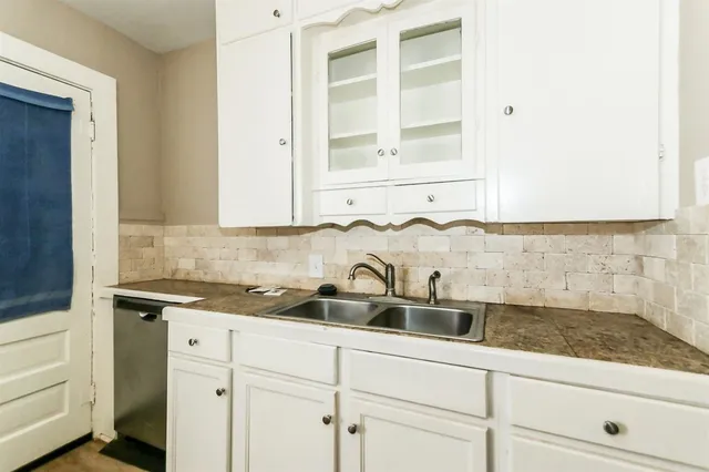a kitchen with a sink and cabinets