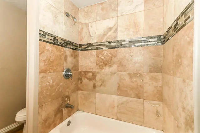 a bathroom with a shower and a tub