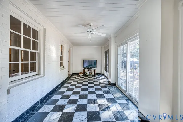 a large room with windows and a rug