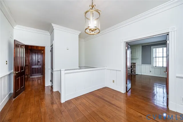 a view of empty room with wooden floor
