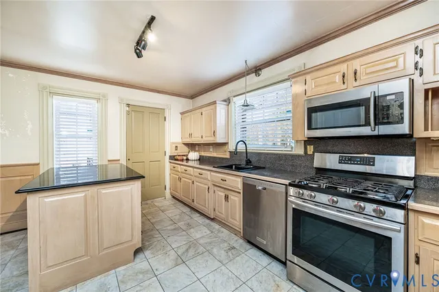 a kitchen with stainless steel appliances granite countertop a stove and a microwave