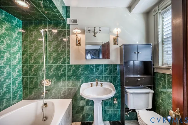 a bathroom with a sink a toilet and bathtub