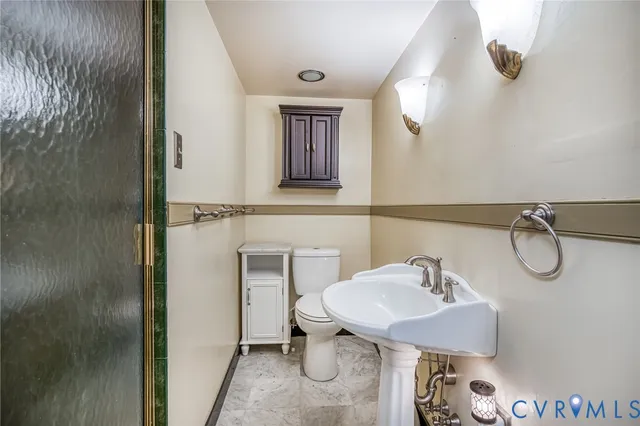 a bathroom with a sink toilet and mirror