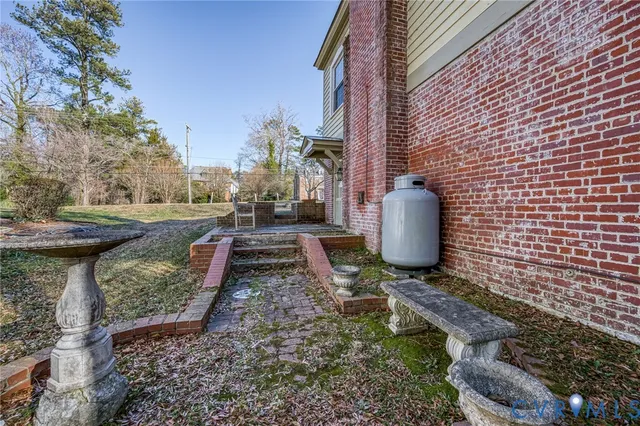 a view of a yard with chairs and a fire pit