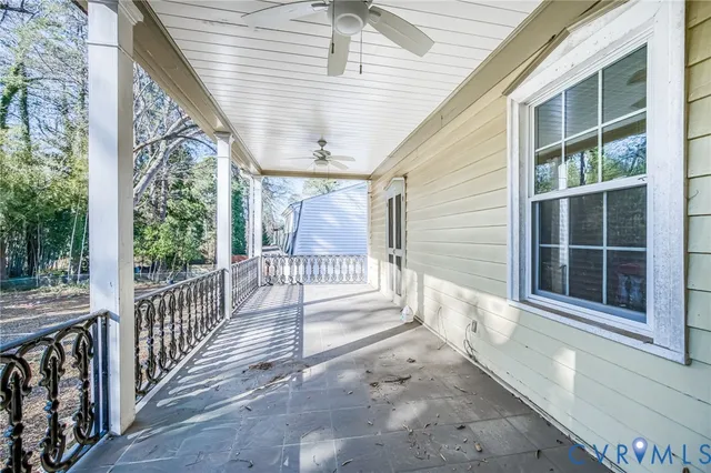 a view of a porch with wooden floor and fence
