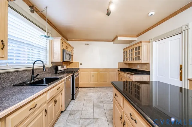 a kitchen with sink a stove and cabinets