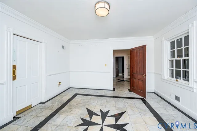 a view of a hallway with entryway wooden floor and cabinet