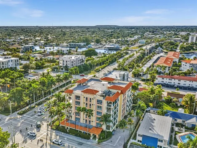 an aerial view of residential houses with outdoor space and trees