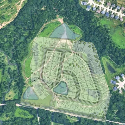 an aerial view of a houses with a yard