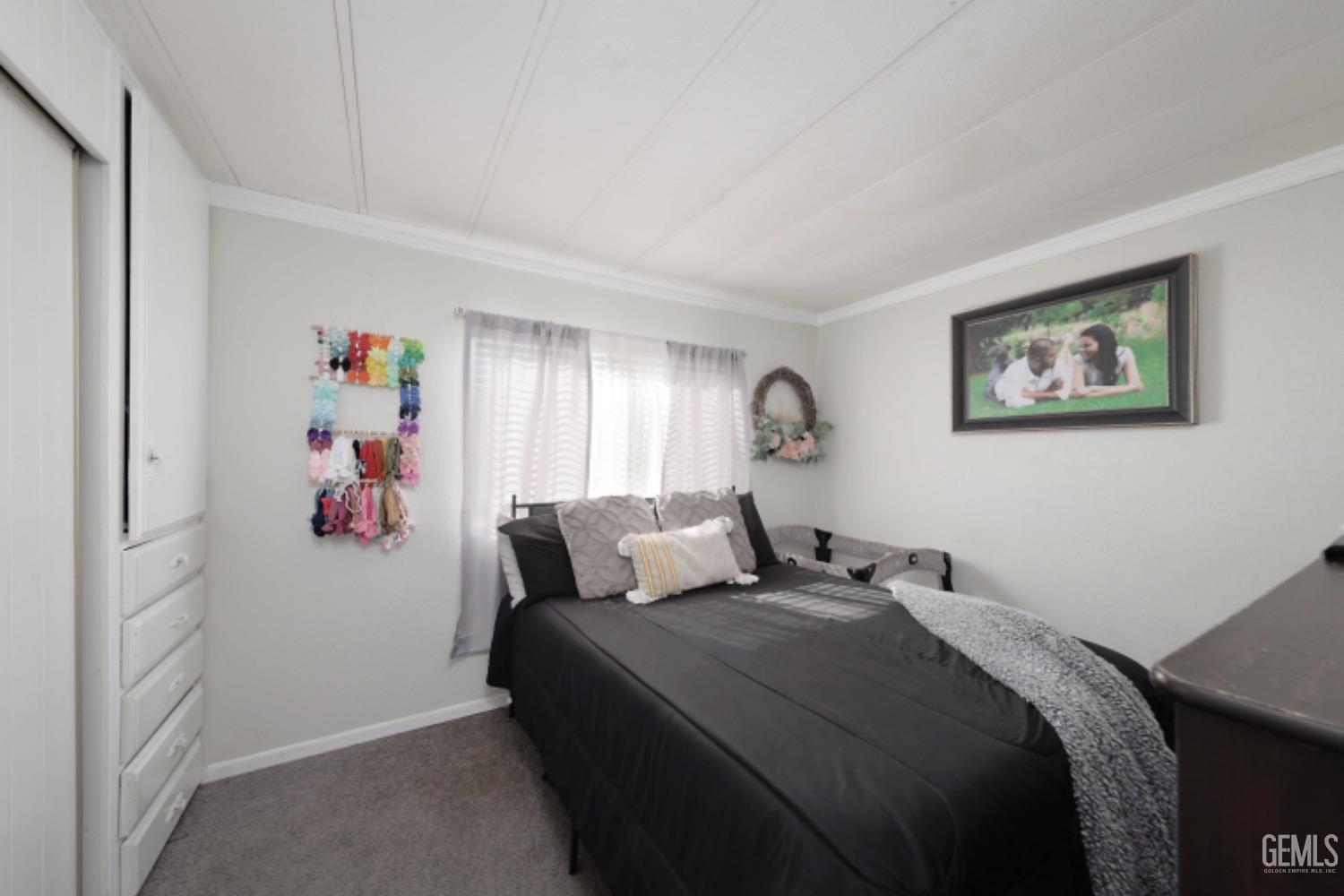 Undisclosed Address Bakersfield, CA 93306 - Photo 12 of 35 a bedroom with a bed and a window