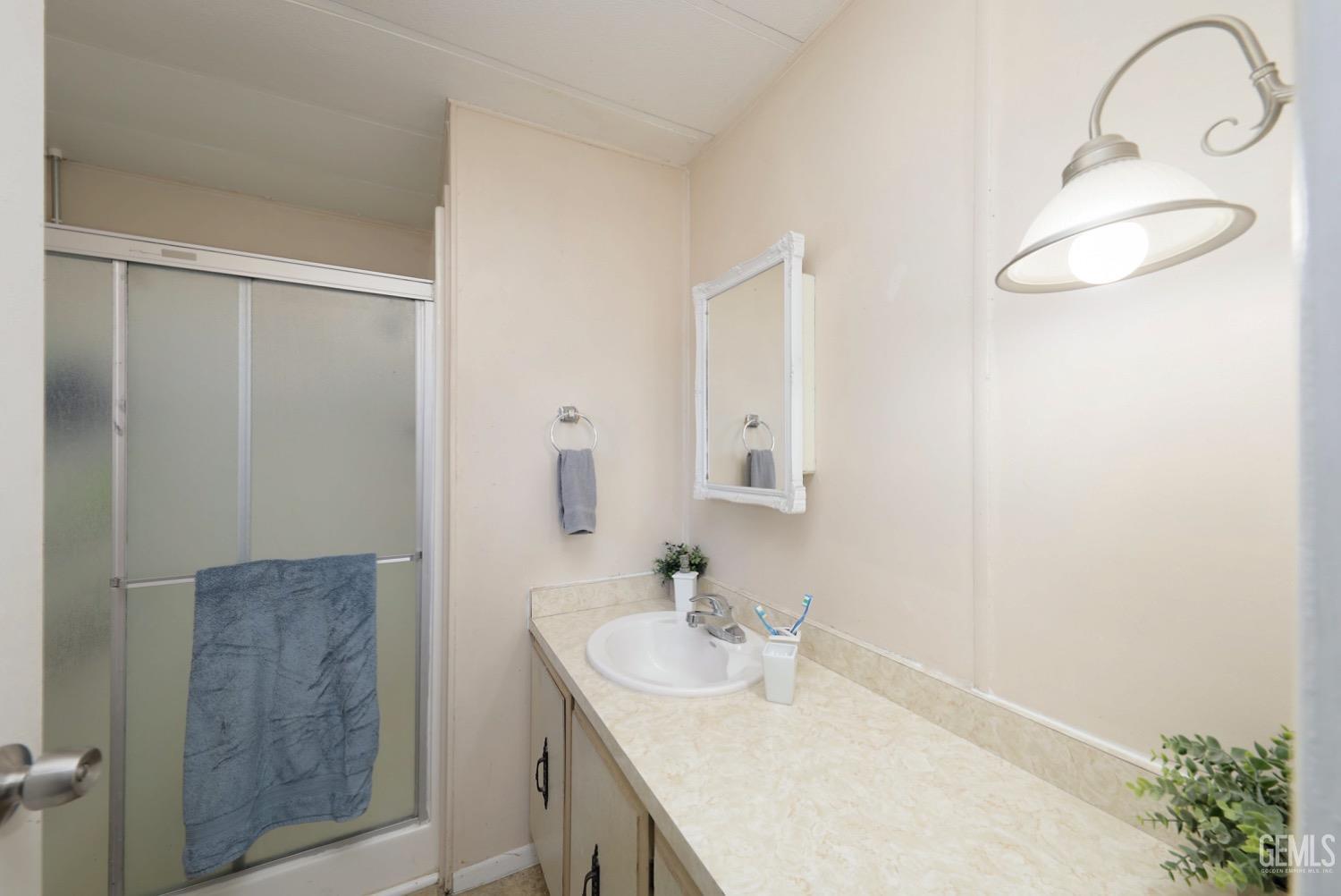 Undisclosed Address Bakersfield, CA 93306 - Photo 16 of 35 a bathroom with a sink and a mirror