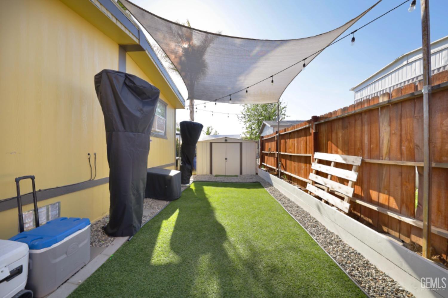 Undisclosed Address Bakersfield, CA 93306 - Photo 2 of 35 a view of a porch with furniture and a yard