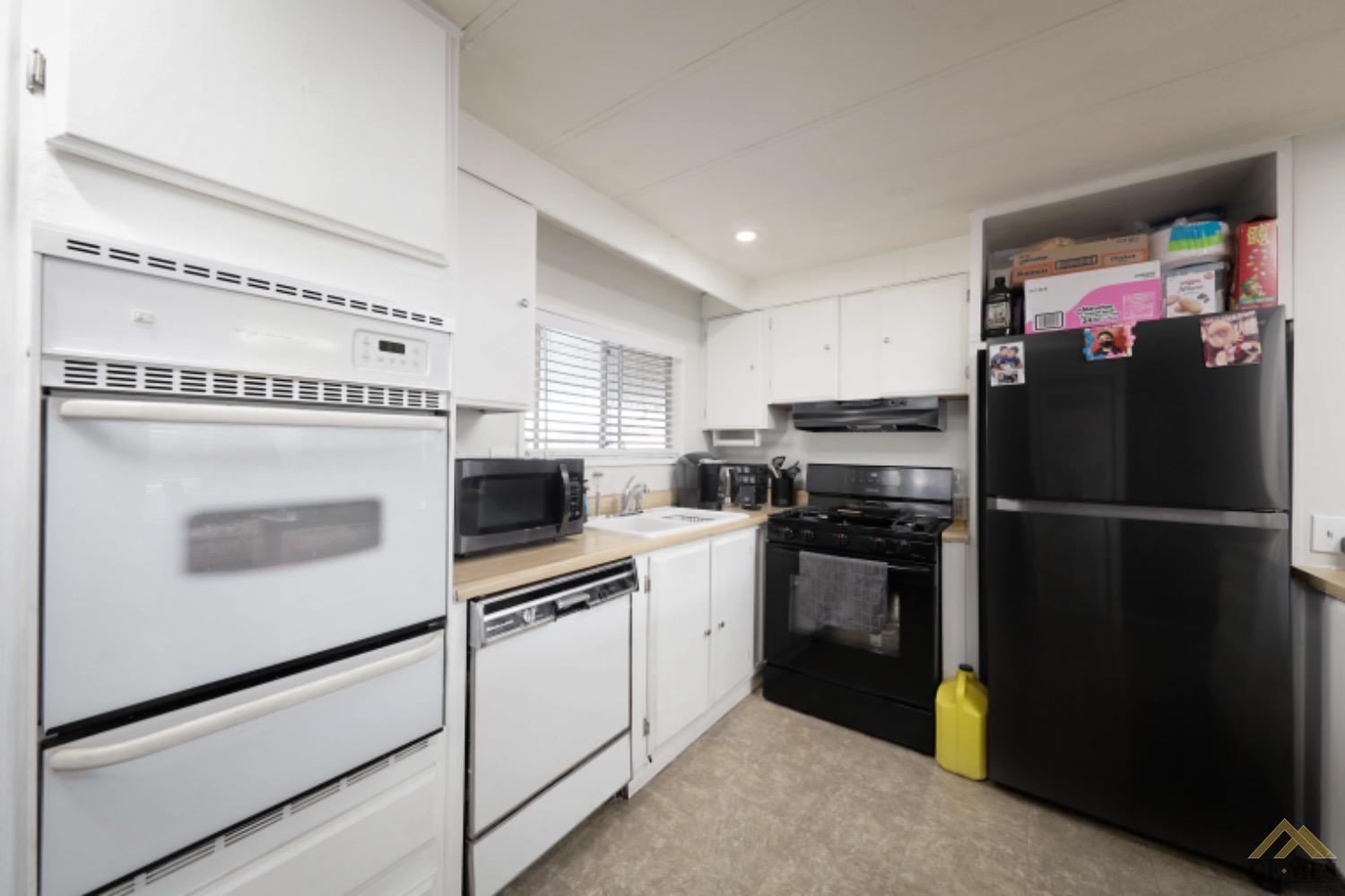 Undisclosed Address Bakersfield, CA 93306 - Photo 25 of 35 a kitchen with a refrigerator stove and microwave