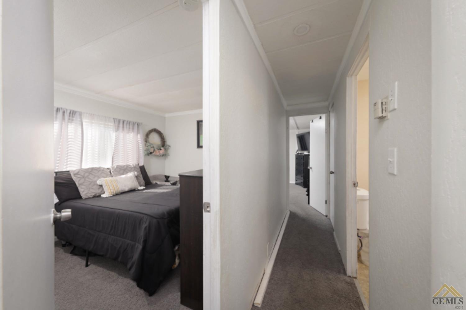 Undisclosed Address Bakersfield, CA 93306 - Photo 26 of 35 a bedroom with a bed and a mirror