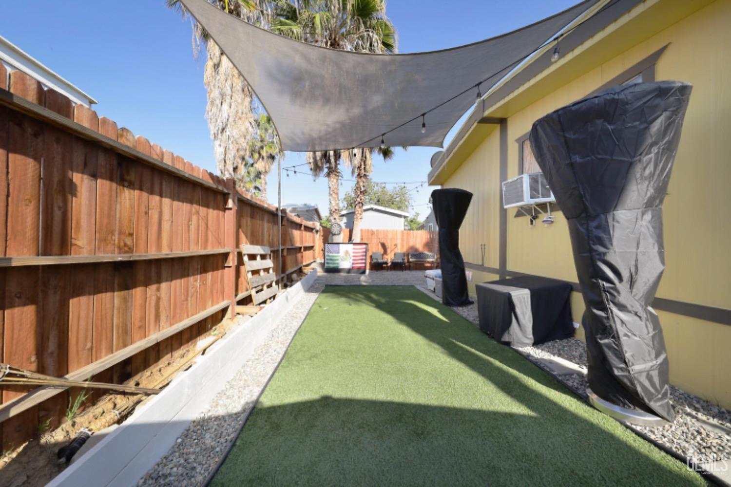 Undisclosed Address Bakersfield, CA 93306 - Photo 3 of 35 a view of a backyard with chairs