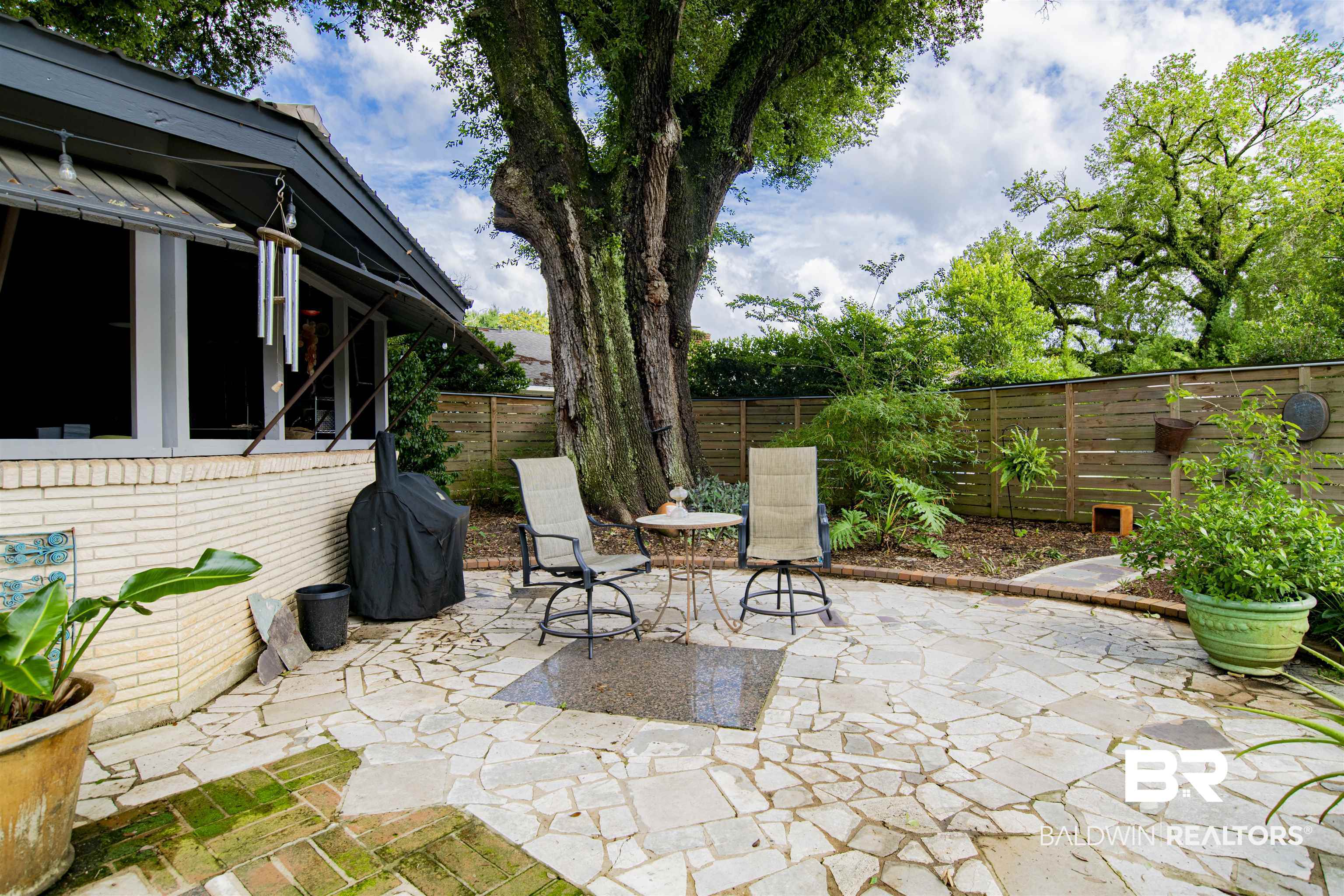 809 Bernard Circle Mobile, AL 36693 - Photo 58 of 75 Expansive flagstone patio with a prominent mature tree providing natural shade