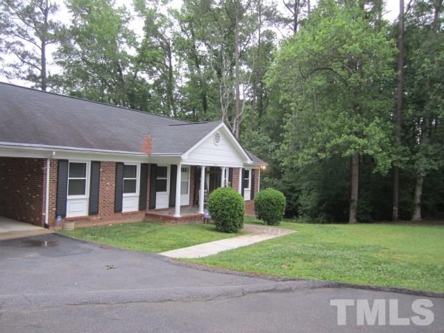 9505 Fonville Road Raleigh, NC 27614 - Photo 2 of 7 a front view of a house with garden