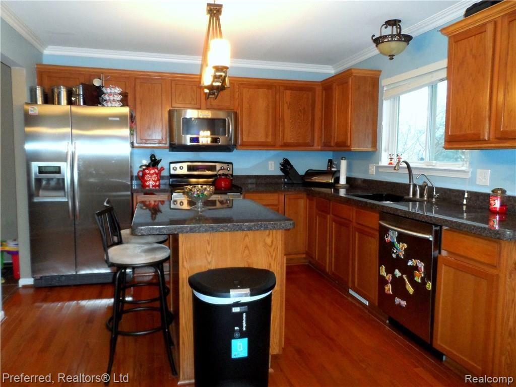 1289 Woodland Springs Drive Howell, MI 48843 - Photo 7 of 39 SPACIOUS KITCHEN WITH SS APPLIANCES & HARDWOOD FLOORING.