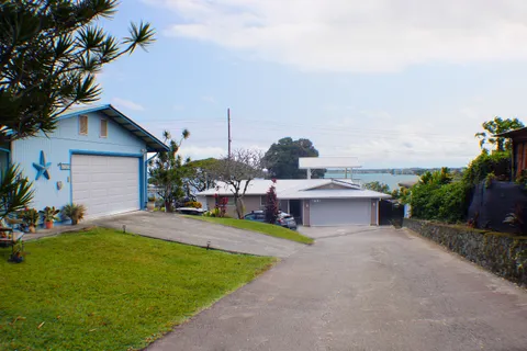 a view of a house with a yard and sitting area