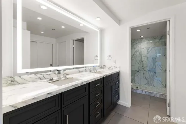 a bathroom with a granite countertop sink mirror and double