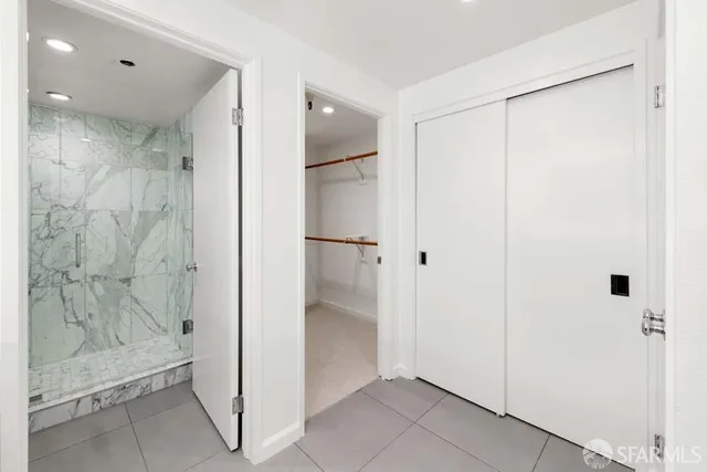 a bathroom with a shower and a glass door