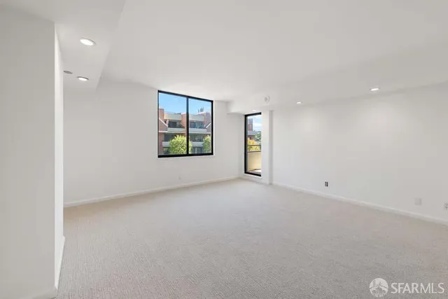 an empty room with windows and closet