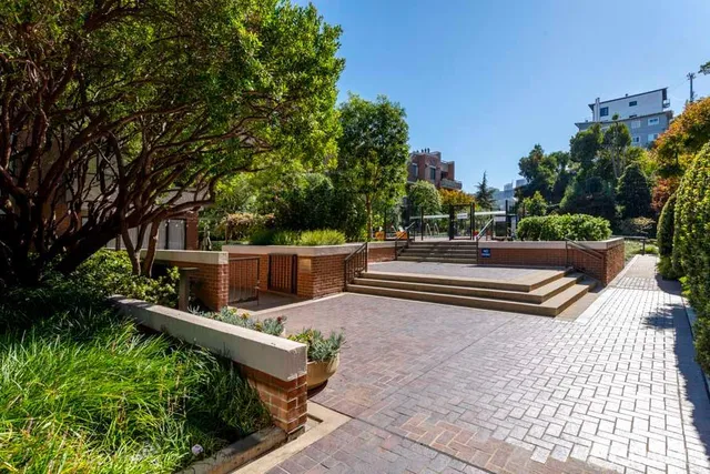 a view of a patio with a table and chairs